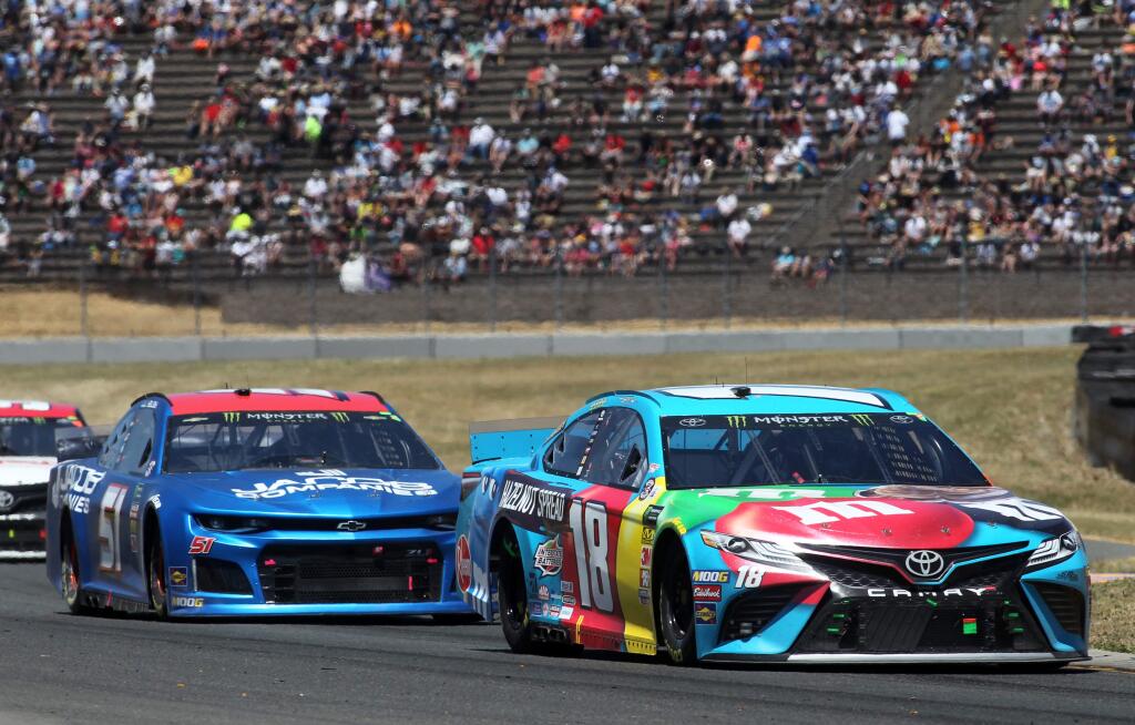 Kyle Busch of the M&M's Hazelnut Toyota drives in front of JJ Yeley of Jacob Companies Chevrolet, during the Toyota / Save Mart 350 Monster Energy Cup NASCAR race at Sonoma Raceway, on Sunday, June 23, 2019. (Photo by Darryl Bush / For The Press Democrat)