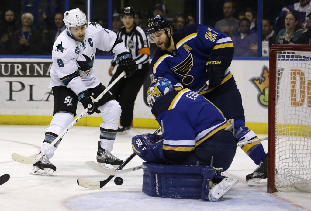 St. Louis Blues goalie Brian Elliott, bottom right, stops a shot from San Jose Sharks' Joe Pavelski, left, as Blues' Alex Pietrangelo watches during the first period of an NHL hockey game Thursday, Feb. 4, 2016, in St. Louis. (AP Photo/Jeff Roberson)
