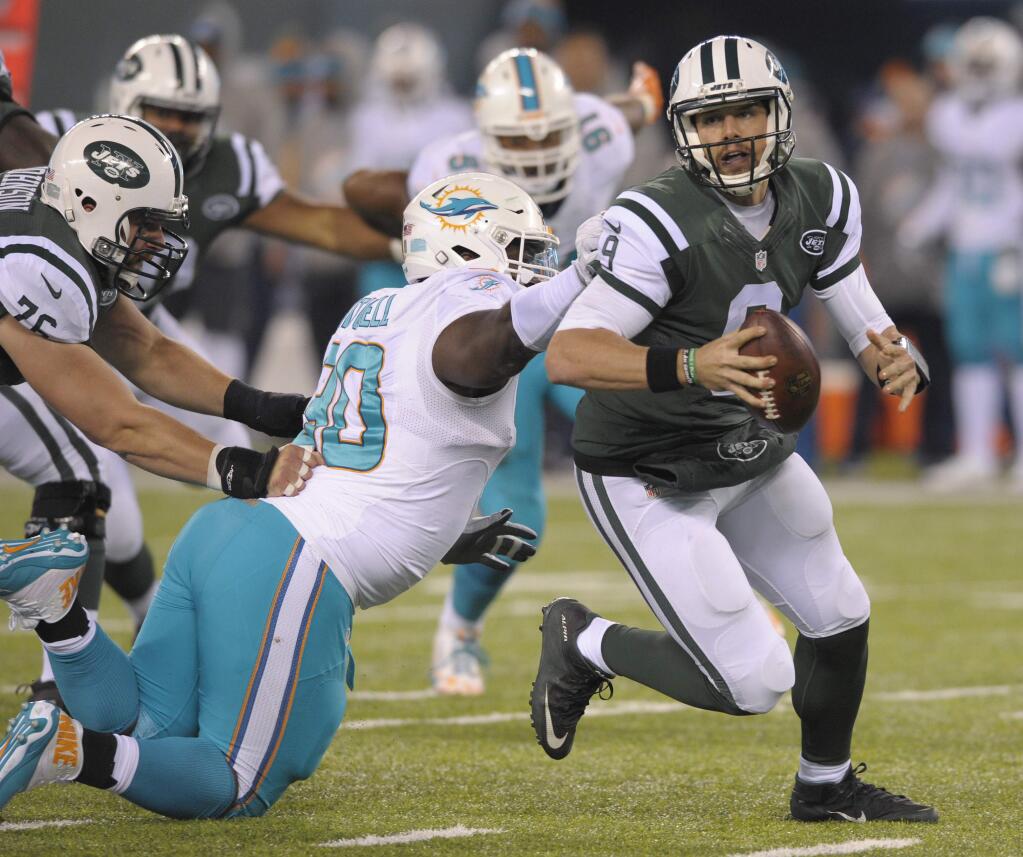 In this Saturday, Dec. 17, 2016 file photo, New York Jets quarterback Bryce Petty (9) tries to avoid Miami Dolphins defensive tackle Earl Mitchell (90) during the fourth quarter in East Rutherford, N.J. (AP Photo/Bill Kostroun, File)