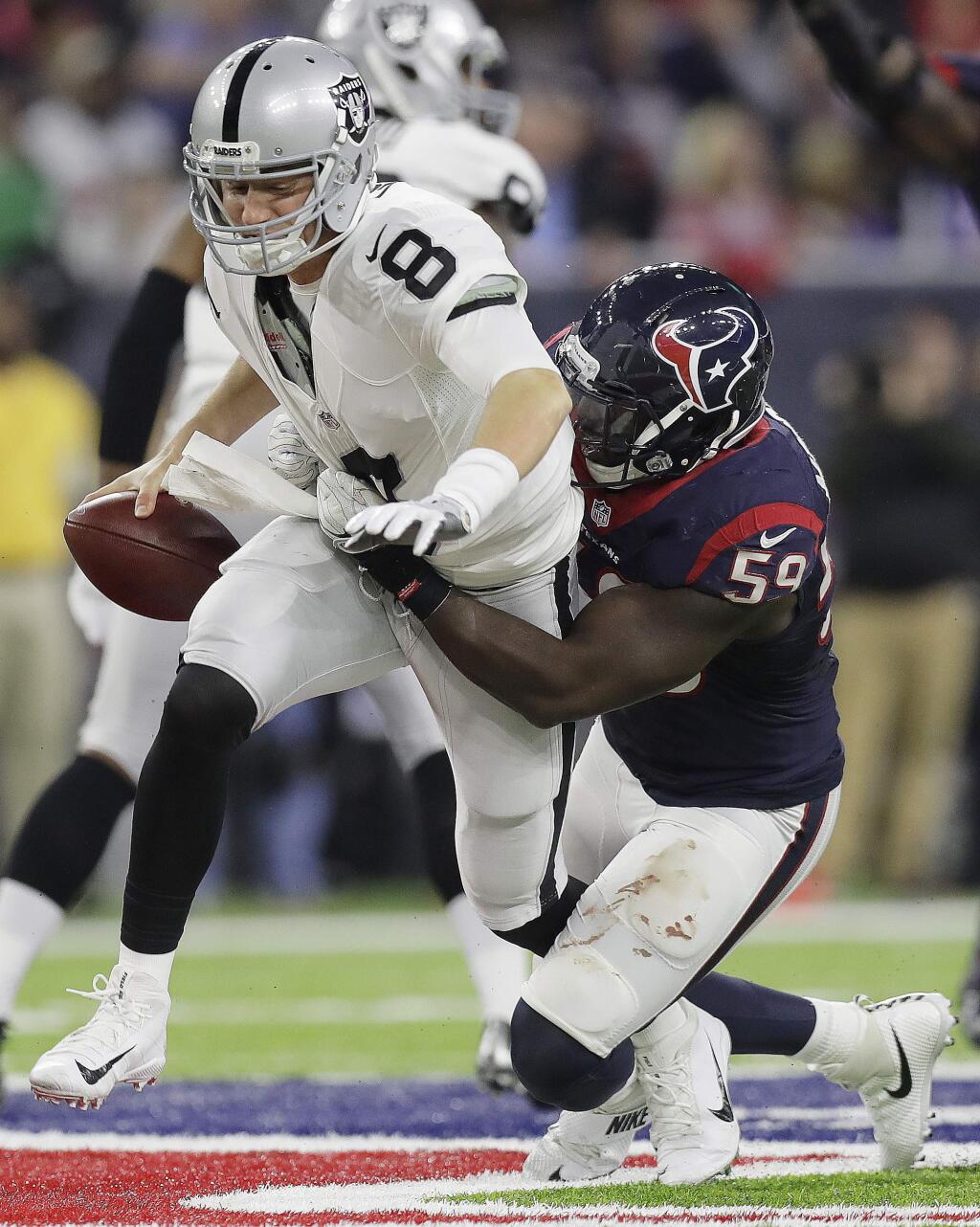 Houston Texans outside linebacker Whitney Mercilus (59) sacks Oakland Raiders quarterback Connor Cook (8) during the second half of an AFC Wild Card NFL football game Saturday, Jan. 7, 2017, in Houston. (AP Photo/Eric Gay)
