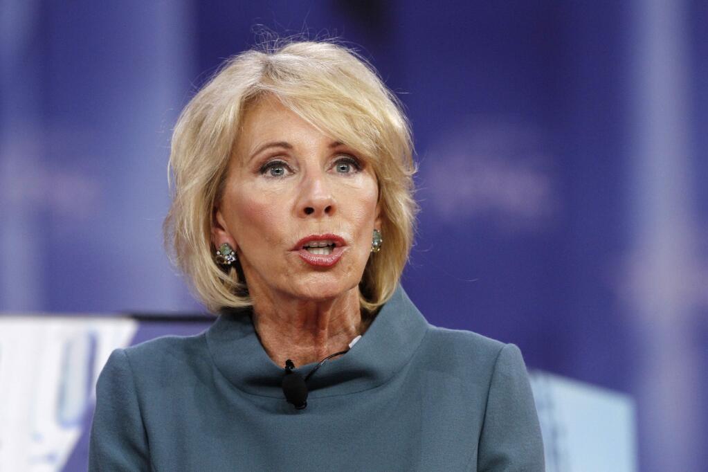 FILE - In this Feb. 22, 2018, file photo, Education Secretary Betsy DeVos speaks during the Conservative Political Action Conference (CPAC), at National Harbor, Md. DeVos has given state education chiefs some 'tough love' as she pushed them to innovate and do better by students. Speaking March 5, 2018, at a conference of the Council of Chief State School Officers, DeVos blasted some schools for exposing children to rats, mold and danger. (AP Photo/Jacquelyn Martin, File)