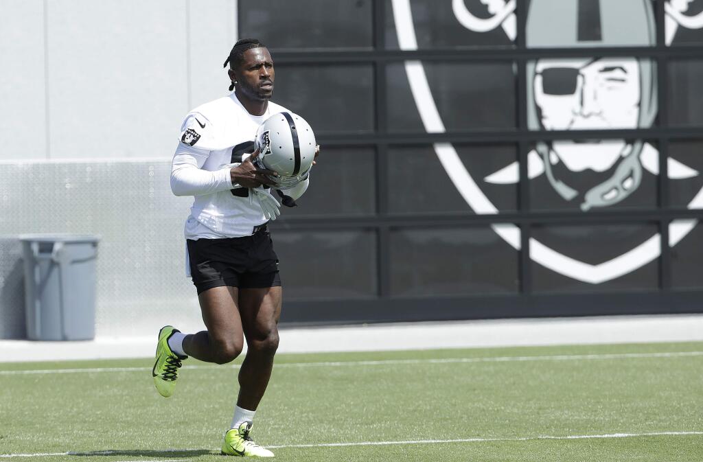 Oakland Raiders wide receiver Antonio Brown warms up during practice at the team's headquarters in Alameda, Tuesday, May 28, 2019. (AP Photo/Jeff Chiu)