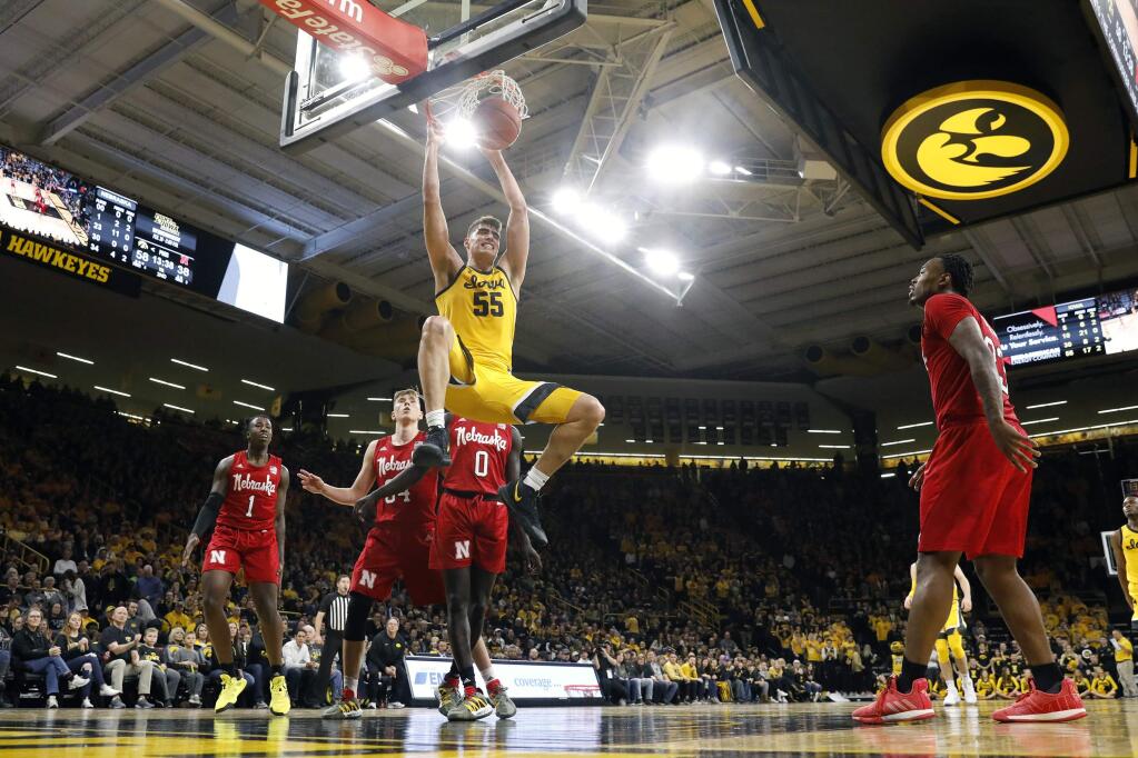 FILE - In this Feb. 8, 2020, file photo, Iowa center Luka Garza (55) dunks the ball during the second half of an NCAA college basketball game against Nebraska, in Iowa City, Iowa. Garza was selected to The Associated Press All-America first team, Friday, March 20, 2020. (AP Photo/Charlie Neibergall, File)
