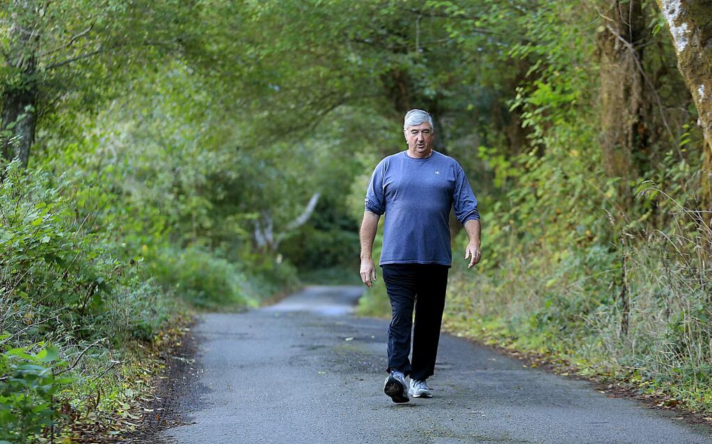 Kevin O'Connell walks Freezeout Road in Duncans Mills. The road is just barely wide enough for one vehicle and has been patched and re-patched over 40 years. Area residents, including O'Connell, are planning to put their property taxes in to an escrow account until the county does something to alleviate the issue. (Kent Porter / Press Democrat ) 2015