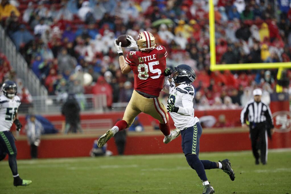 San Francisco 49ers tight end George Kittle (85) catches a pass over Seattle Seahawks defensive back Delano Hill during the second half of an NFL football game in Santa Clara, Calif., Sunday, Dec. 16, 2018. (AP Photo/Tony Avelar)