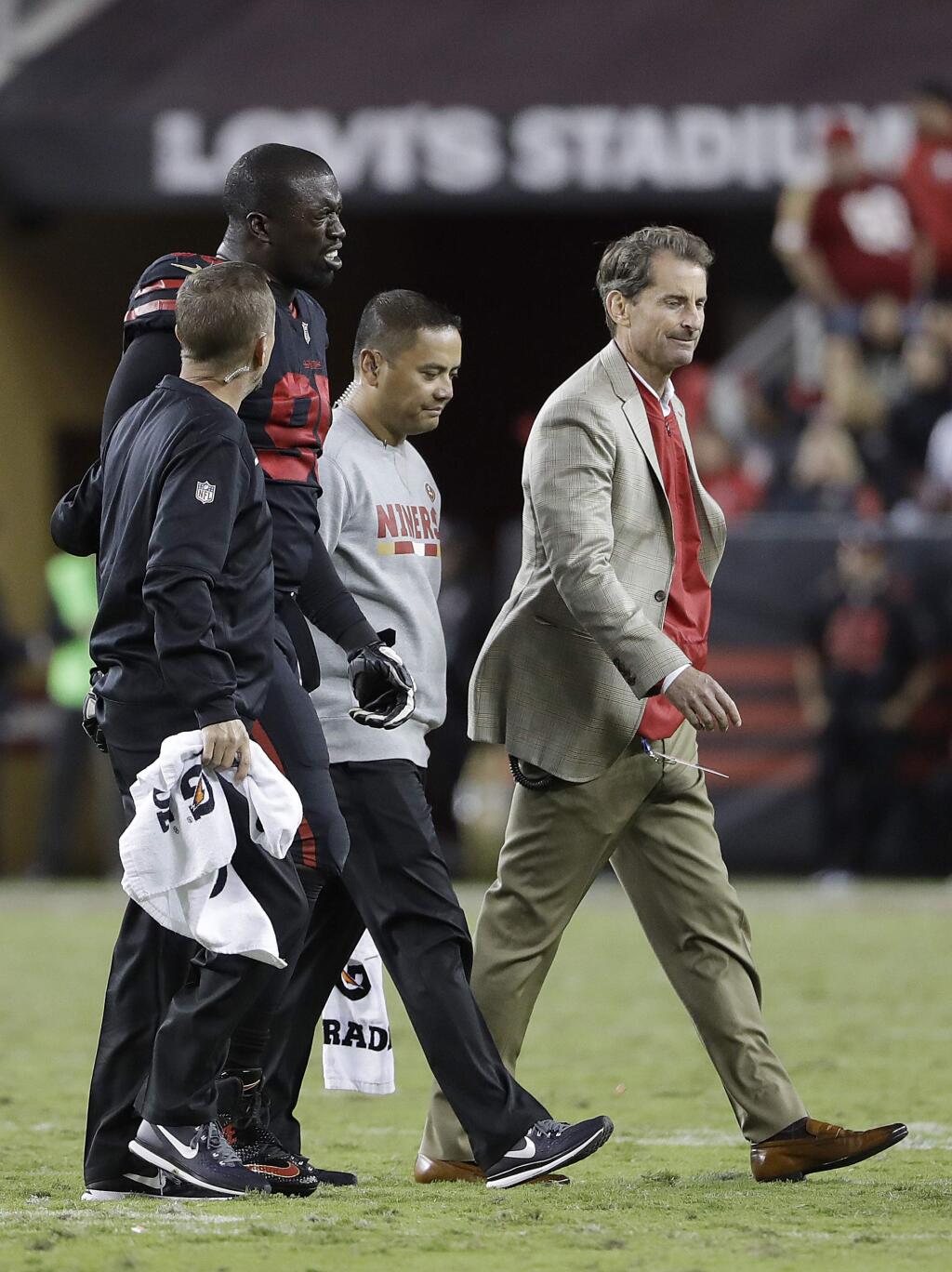San Francisco 49ers defensive end Tank Carradine (95) walks off the field with trainers during the second half of an NFL football game against the Los Angeles Rams in Santa Clara, Calif., Thursday, Sept. 21, 2017. (AP Photo/Marcio Jose Sanchez)