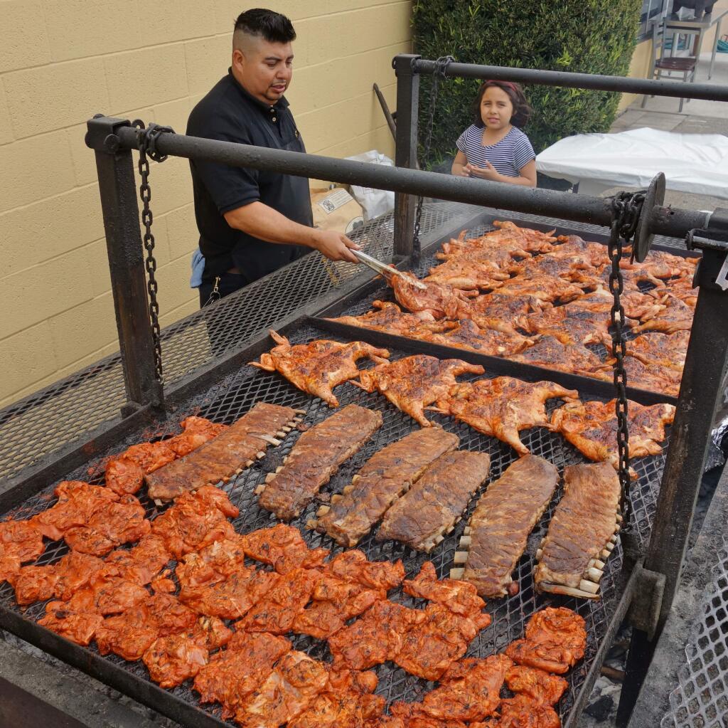 Cesar Segura grills up chicken and ribs at What a Chicken!! HOUSTON PORTER FOR THE ARGUS-COURIER