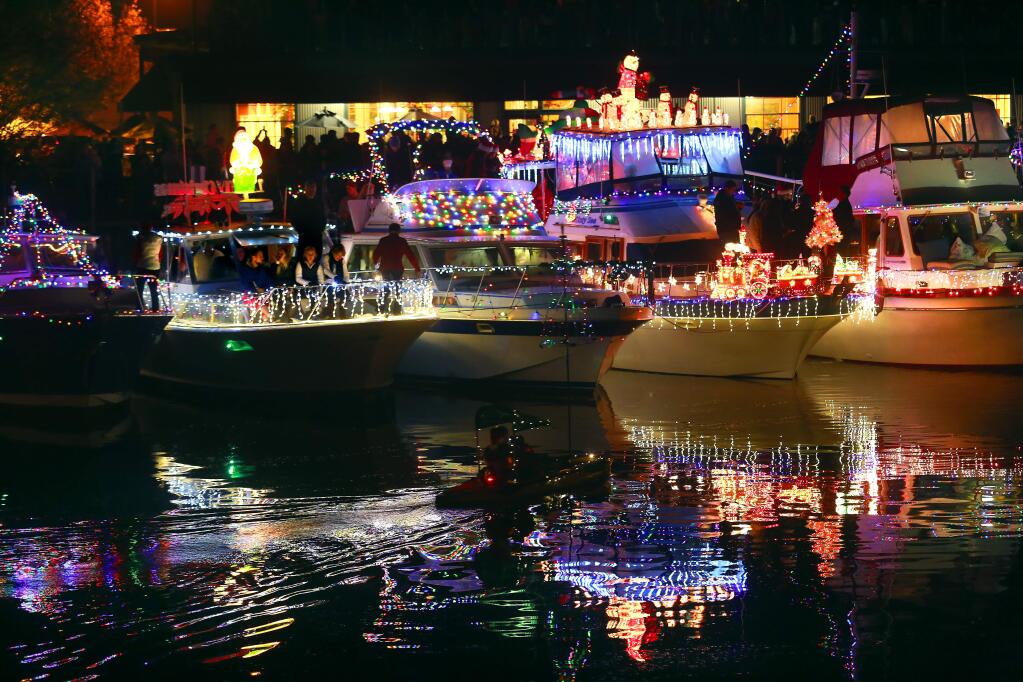 The Petaluma Lighted Boat Parade cruised into the downtown turning basin on Saturday, December 13, 2014. (photo by John Burgess/The Press Democrat)