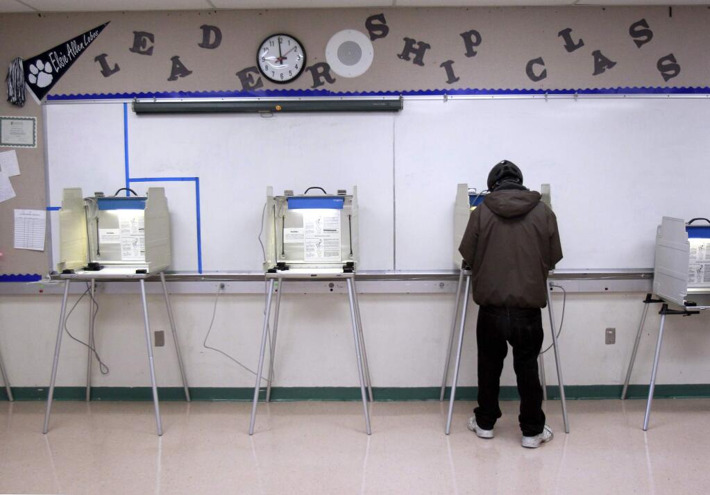 Omar Eljumaily votes in the leadership room at Elsie Allen High School. (JOHN BURGESS / PD FILE)