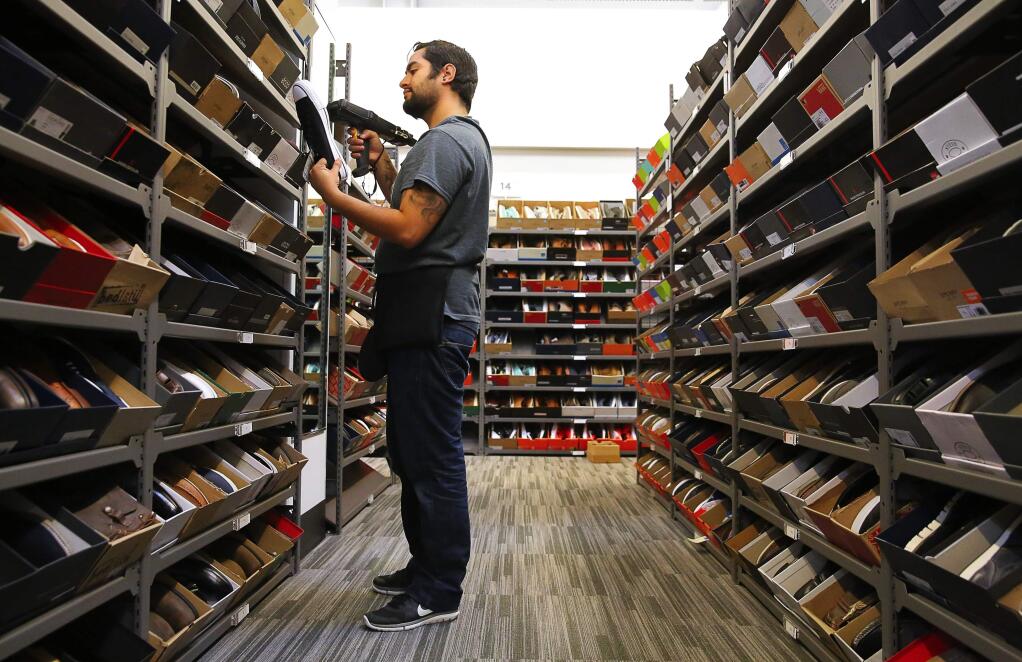 Ever Garcia scans prices for shoes at the new Nordstrom Rack at Coddingtown Mall, in Santa Rosa on Thursday, Sept. 22, 2016. (CHRISTOPHER CHUNG/ PD)
