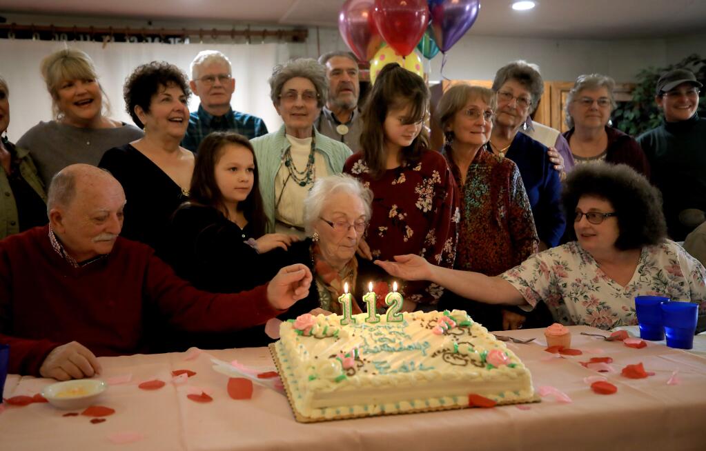 Edith Ceccarelli celebrates her 112th trip around the sun, Wednesday, Feb. 5, 2020 with the help of her cousins at the Willits Senior Center. Ceccarelli was born and raised in Willits. (Kent Porter / The Press Democrat) 2020