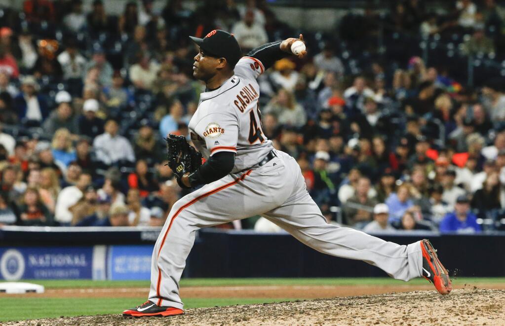 FILE - In this May 19, 2016, file photo, San Francisco Giants closer Santiago Casilla pitches against the San Diego Padres in the ninth inning of the Giants' 3-1 victory in a baseball game in San Diego. Relief pitcher Santiago Casilla is crossing the bay again, re-joining the Oakland Athletics with a two-year contract Friday, Jan. 20, 2017, after seven seasons with San Francisco. Casilla has spent his entire big league career between the two Bay Area teams; his initial six seasons were with Oakland. (AP Photo/Lenny Ignelzi, File)