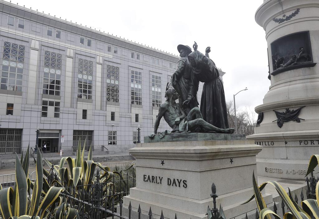 This Friday, March 2, 2018 photo shows a statue of a Native American, bottom, with Sir Francis Drake, top left, and Father Junipero Serra in San Francisco. San Francisco's arts commission is considering removing a statue that some say is degrading to Native Americans. The city's arts commission is scheduled to discuss the sculpture Monday and has the final say on its fate. (AP Photo/Jeff Chiu)
