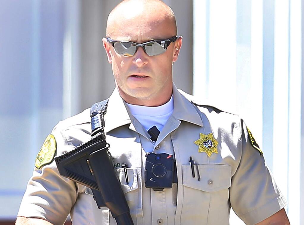 A Sonoma County sheriff's deputy with his body camera on during the Windsor armored car robbery, Tuesday July 12, 2016. (Kent Porter / Press Democrat) 2016