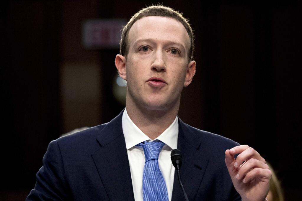 FILE - In this April 10, 2018, file photo, Facebook CEO Mark Zuckerberg testifies before a joint hearing of the Commerce and Judiciary Committees on Capitol Hill in Washington. Weeks after Facebook refused to remove a doctored video of House Speaker Nancy Pelosi slurring her words, Zuckerberg is getting a taste of his own medicine: fake footage showing him gloating over his one-man domination of the world. (AP Photo/Andrew Harnik, File)