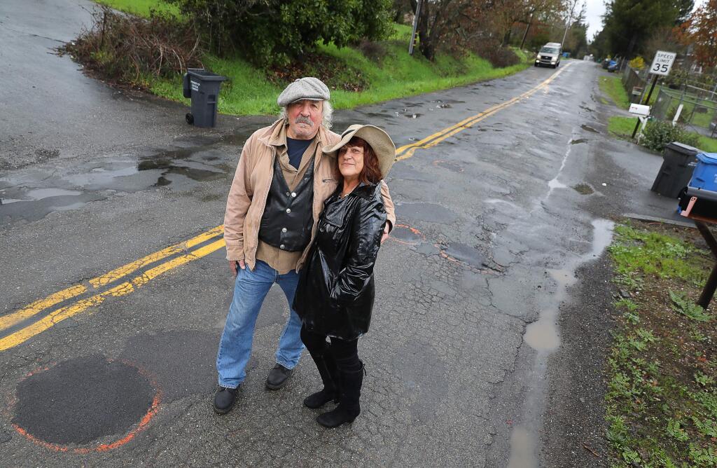 Christopher Chung / The Press DemocratSanta Rosa couple Peter Babcock, 72, and Lauren Roy, 67, who call themselves the Pothole Bandits, mark potholes around the county, such as the ones recently patched along Cunningham Road, near Schaeffer Road, south of Sebastopol.
