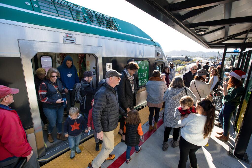 Passengers disembark the SMART train at the newly opened Larkspur SMART Train Station after taking the inaugural ride to Larkspur, Calif., on Saturday, December 14, 2019. (Photo by Darryl Bush / For The Press Democrat)
