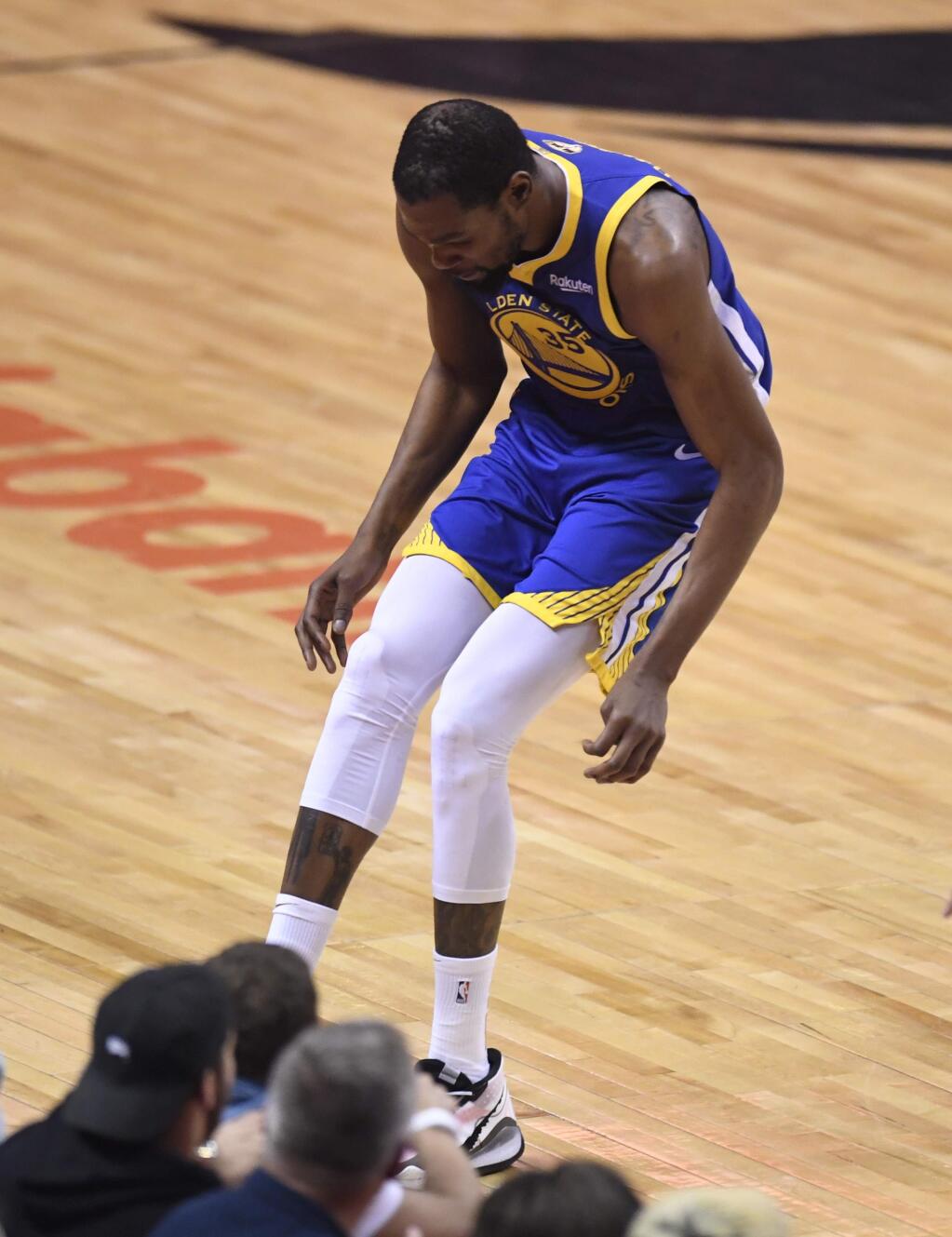 Golden State Warriors forward Kevin Durant hobbles after injuring his right leg during first-half action in Game 5 of the NBA Finals against the Toronto Raptors in Toronto, Monday, June 10, 2019. (Frank Gunn/The Canadian Press via AP)