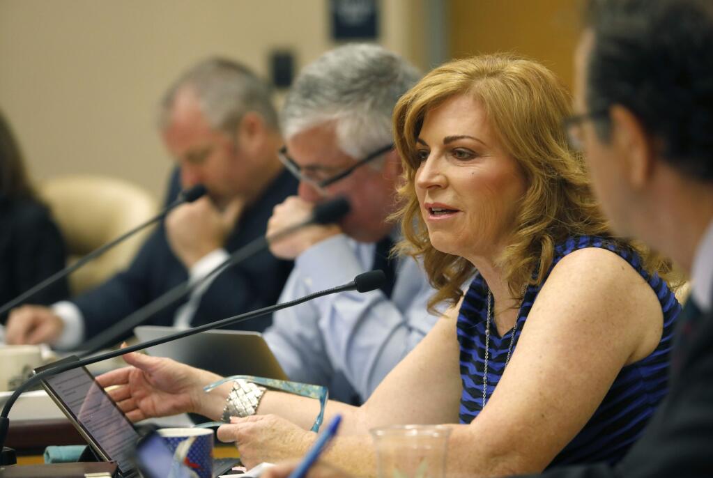 Sonoma County Supervisor Shirlee Zane speaks during the Board of Supervisors meeting in Santa Rosa on Tuesday, July 10, 2018. Pictured in the foreground is County Counsel Bruce Goldstein. In the background are Supervisor David Rabbitt and Supervisor James Gore. (Beth Schlanker/The Press Democrat file)