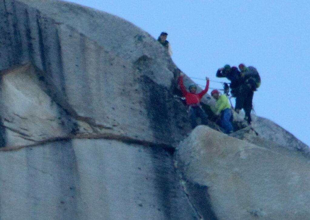 Kevin Jorgenson, in red, of Santa Rosa, celebrates his free climb of El Capitan in the Yosemite Valley with Tommy Caldwell, in yellow, on January 14. (Photo by John Burgess and Michael Eller / The Press Democrat)