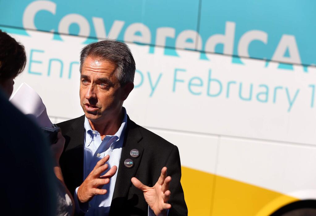Covered California Executive Director Peter Lee talks in front of the Covered California tour bus, during a stop at the Petaluma Health Center, in Petaluma on Monday, Nov. 10, 2014. (CHRISTOPHER CHUNG/ PD)