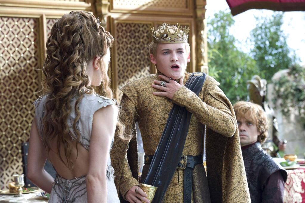 This image released by HBO shows Natalie Dormer, left, Jack Gleeson, Peter Dinklage, right in a scene from 'Game of Thrones.' The series garnered 19 Emmy Award nominations on Thursday, July 10, 2014, including one for best drama series. (AP Photo/HBO, Macall B. Polay)