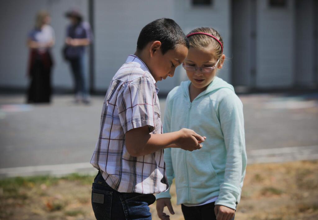 Petaluma, CA, USA. Monday, August 22, 2016._Austin Maack, 9, shows Josie Ielmorini,8, a lizard he found while playing during recess at the Union School, a one-room schoolhouse with students from K-6th.(CRISSY PASCUAL/ARGUS-COURIER STAFF)