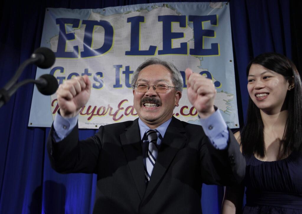 FILE - In this Nov. 8, 2011, file photo, San Francisco interim mayor Ed Lee smiles as his daughter, Brianna, right, looks on at his campaign headquarters for mayor in San Francisco, after the polls closed. The San Francisco Chronicle reported that Lee died early Tuesday, Dec. 12, 2017. He was 65. (AP Photo/Paul Sakuma, File)