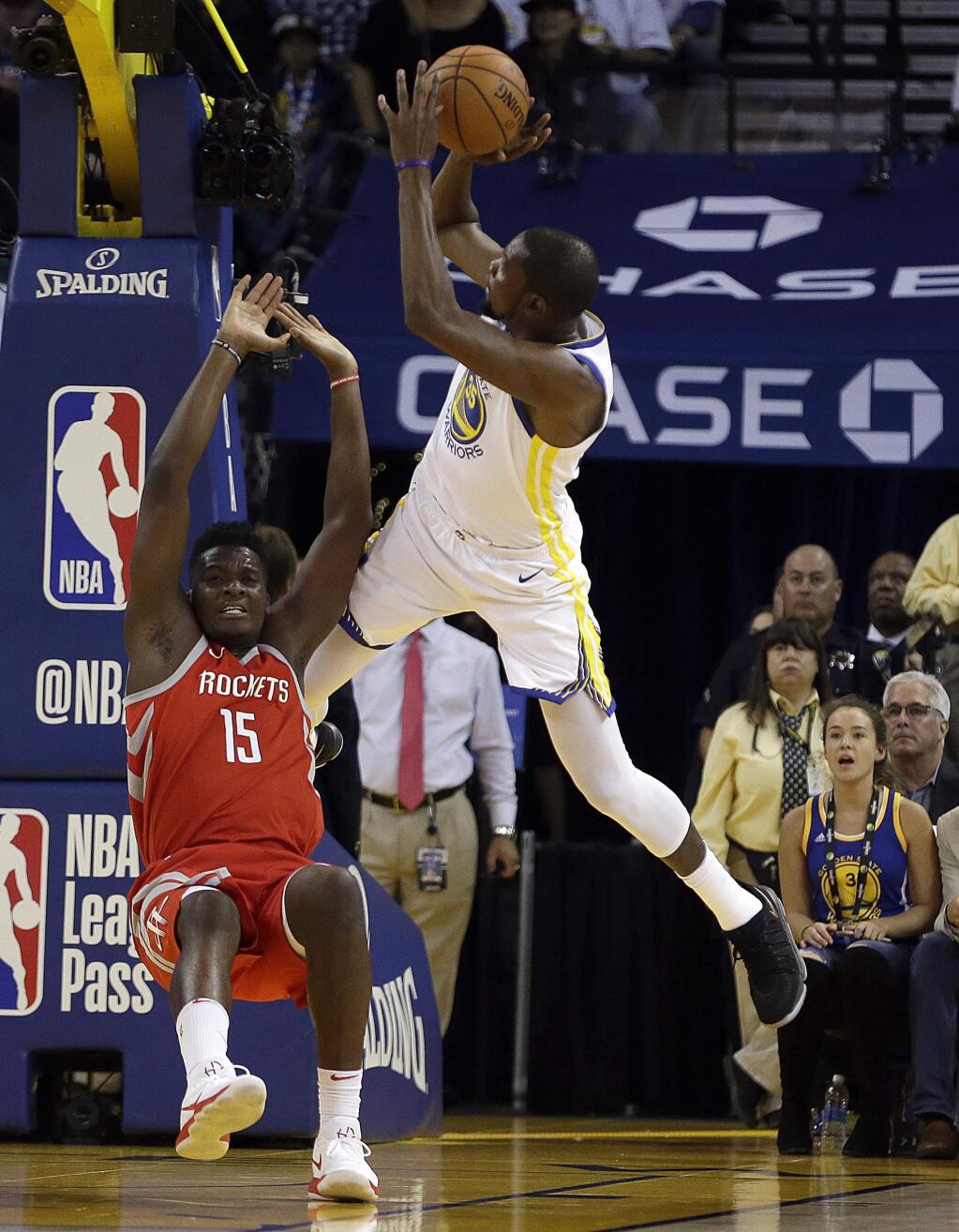 The Golden State Warriors' Kevin Durant, right, shoots over the Houston Rockets' Clint Capela (15) during the first quarter Tuesday, Oct. 17, 2017, in Oakland. (AP Photo/Ben Margot)