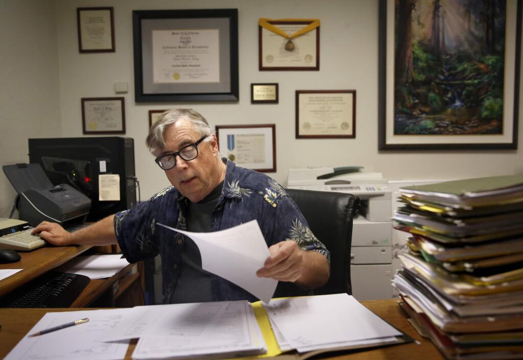 CPA Rob Kirby prepares tax forms for a client at his office in Santa Rosa, on Tuesday, April 12, 2016. (BETH SCHLANKER/ The Press Democrat)
