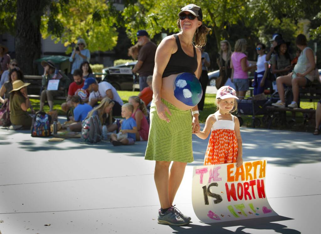 Leigh Felix marches with her daughters, Lana and Isabelle (not pictured) in the Climate Strike in Petaluma on Friday, September 20, 2019. (CRISSY PASCUAL/ARGUS-COURIER STAFF)
