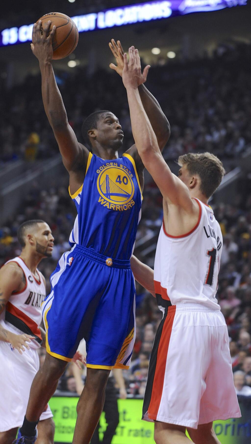 Golden State Warriors' Harrison Barnes (40) shoots against Portland Trail Blazers' Meyers Leonard (11) during the first half of an NBA basketball game in Portland, Ore., Tuesday, March 24, 2015. (AP Photo/Greg Wahl-Stephens)
