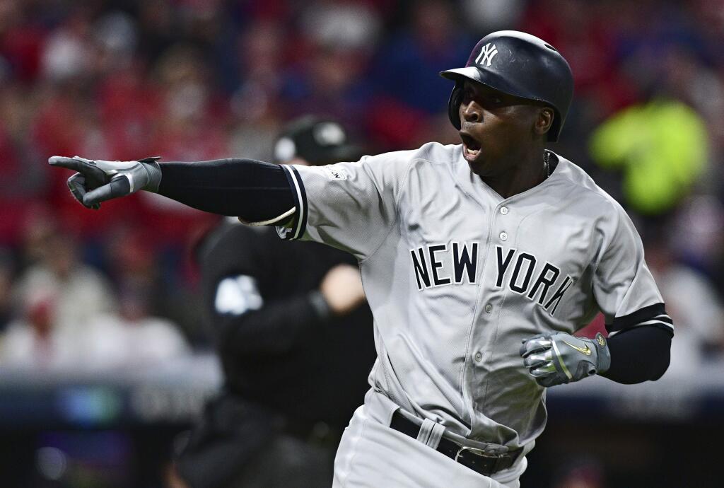 The New York Yankees' Didi Gregorius points to the dugout after hitting a two-run home run off Cleveland Indians starting pitcher Corey Kluber during the third inning of Game 5 of the American League Division Series, Wednesday, Oct. 11, 2017, in Cleveland. (AP Photo/David Dermer)