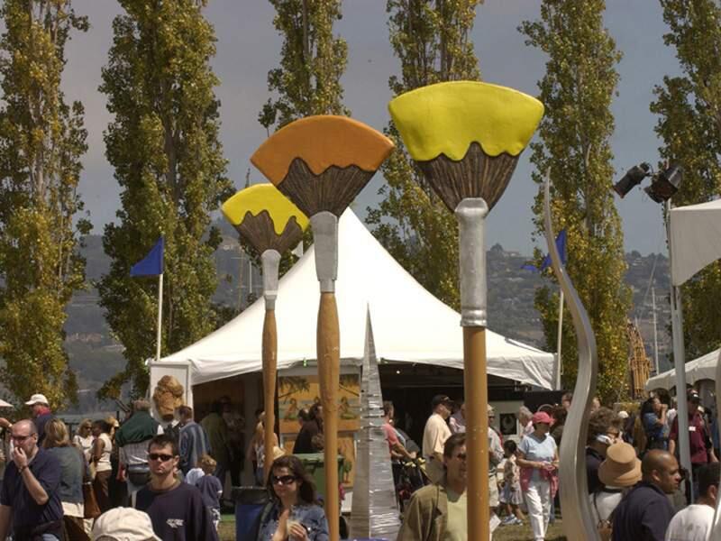The crowd mingls among giant paint brushes at the Sausalito Arts Festival. ho