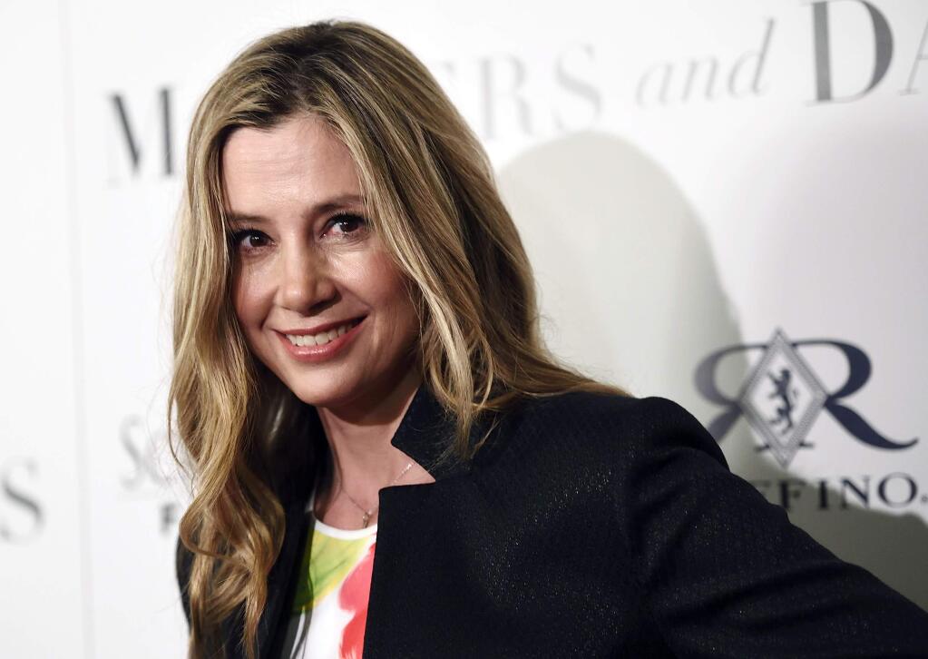 FILE - In this April 28, 2016, file photo, Mira Sorvino, a cast member in 'Mothers and Daughters,' poses at the premiere of the film at the London West Hollywood Hotel Screening Room in West Hollywood, Calif. The Oscar-winning actress wrote a guest column in The Hollywood Reporter on Friday, Dec. 8, 2017, that says she's still glad she revealed her sexual misconduct allegations against Harvey Weinstein despite facing a backlash by some who accuse her of keeping silent in order to save her career. (Photo by Chris Pizzello/Invision/AP, File)