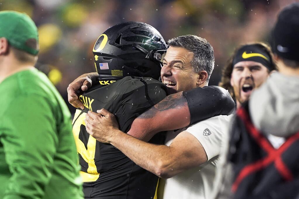 In this Dec. 6, 2018, file photo, Oregon coach Mario Cristobal, right, celebrates with offensive lineman Shane Lemieux (68) after Oregon defeated Utah 37-15 for the Pac-12 Conference championship, in Santa Clara. Cristobal was named The Associated Press Pac-12 Coach of the Year Thursday, Dec. 12, 2019. (AP Photo/Tony Avelar, File)