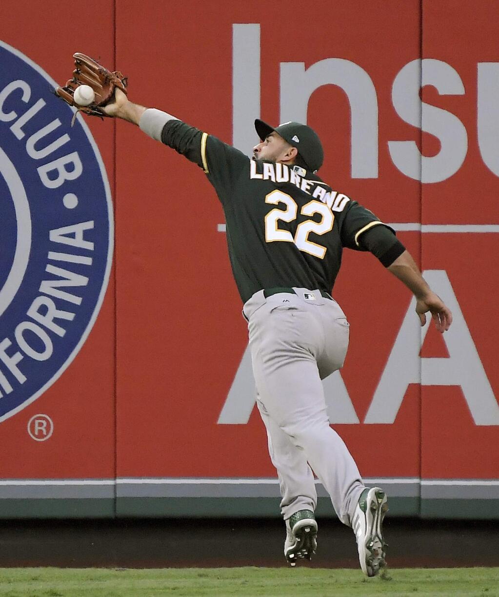 Oakland Athletics center fielder Ramon Laureano makes the catch on a fly ball hit by the Los Angeles Angels' Justin Upton during the third inning Saturday, Aug. 11, 2018, in Anaheim. Laureano then threw out Eric Young Jr. at first. Young had run from first to beyond second and the back to first. (AP Photo/Mark J. Terrill)