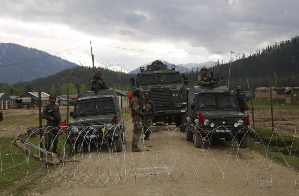 Indian army soldiers stand guard inside a military camp after a group of militants stormed it in Panzgam 127 Kilometers (79 miles) northwest of Srinagar, Indian controlled Kashmir, Thursday, April 27, 2017. A 70-year-old civilian was killed and seven people were injured during an anti-India protest that erupted Thursday following a gun-battle that killed three Indian soldiers and two suspected rebels in disputed Kashmir, police said. (AP Photo/Mukhtar Khan)