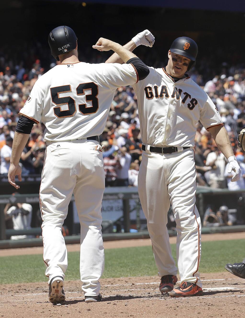 The San Francisco Giants' Nick Hundley, right, celebrates after hitting a two-run home run that scored Austin Slater (53) during the fourth inning against the Colorado Rockies in San Francisco, Wednesday, June 28, 2017. (AP Photo/Jeff Chiu)
