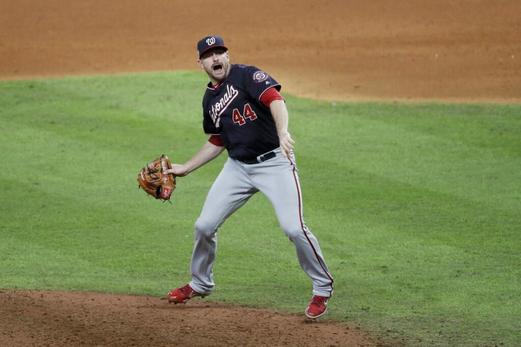 Washington Nationals relief pitcher Daniel Hudson celebrates after Game 7 of the baseball World Series against the Houston Astros Wednesday, Oct. 30, 2019, in Houston. The Nationals won 6-2 to win the series. (AP Photo/Sue Ogrocki)