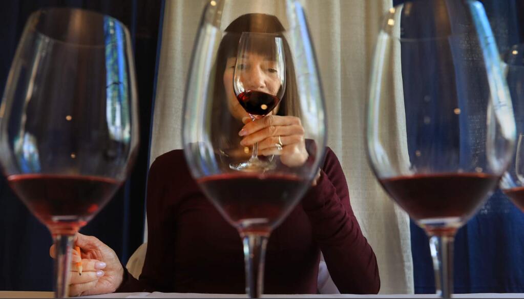 Wine judge Ellen Landis examines the texture of a pinot noir wine during the Sonoma County Harvest Fair Wine Competition, Wednesday September 20, 2017 at the Sonoma County Fairgrounds in Santa Rosa. (Kent Porter / The Press Democrat) 2017