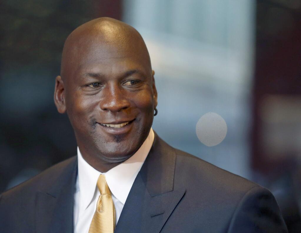 FILE - In this Aug. 21, 2015, file photo, former NBA star and current owner of the Charlotte Hornets, Michael Jordan, smiles at reporters in Chicago. Jordan announced Monday, July 25, 2016, he's giving $1 million to the Institute for Community-Police Relations and $1 million to the NAACP Legal Defense Fund to help build trust between blacks and law enforcement following several disturbing clashes around the country. (AP Photo/Charles Rex Arbogast, File)