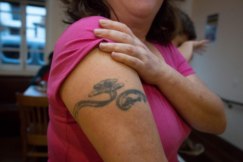 Laura Hinerfeld shows off her ugly tattoo during the third annual Ugly Tattoo Contest held at B&V Whiskey Bar & Grille in 2017. (Jeremy Portje / For The Press Democrat)