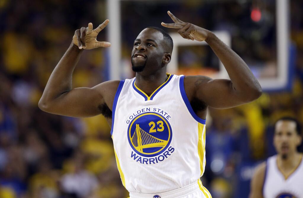 Golden State Warriors' Draymond Green (23) reacts after scoring against the Houston Rockets during the first half in Game 5 of a first-round NBA basketball playoff series Wednesday, April 27, 2016, in Oakland, Calif. (AP Photo/Marcio Jose Sanchez)