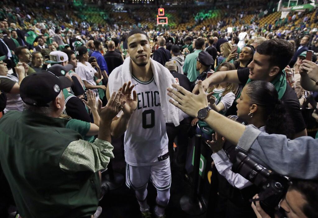 Fans reach out to Boston Celtics forward Jayson Tatum after Game 5 of the team's NBA Eastern Conference final against the Cleveland Cavaliers, Wednesday, May 23, 2018, in Boston. The Celtics won 96-83. (AP Photo/Charles Krupa)