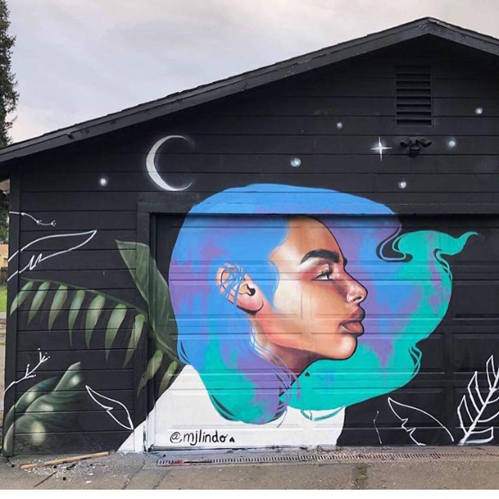 Husband-and-wife artists Joshua Lawyer and MJ Lindo-Lawyer are angry that a mural they painted, in conjunction with street artist Big Hepos, was defaced over the weekend. The mural, pictured here when it was created last year, is on Santa Rosa Avenue in a vacant used car lot. (MJ LINDO-LAWYER)