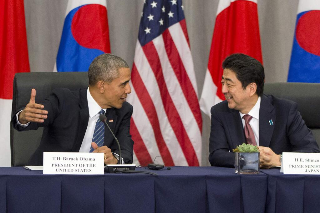 President Barack Obama speaks with Japanese Prime Minister Shinzo Abe during their meeting with South Korean President Park Geun-hye at the Nuclear Security Summit in Washington, Thursday, March 31, 2016. (AP Photo/Jacquelyn Martin)
