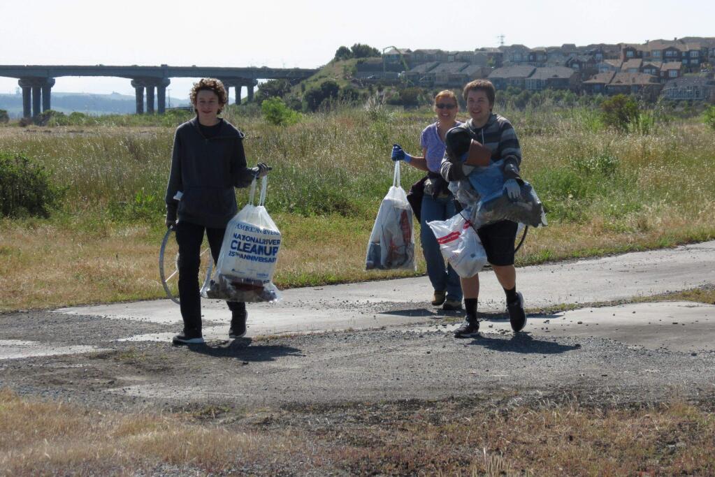 Petaluma High School students remove trash from the old Pomeroy site along McNear Channel. Photo by Stephanie Bastianon