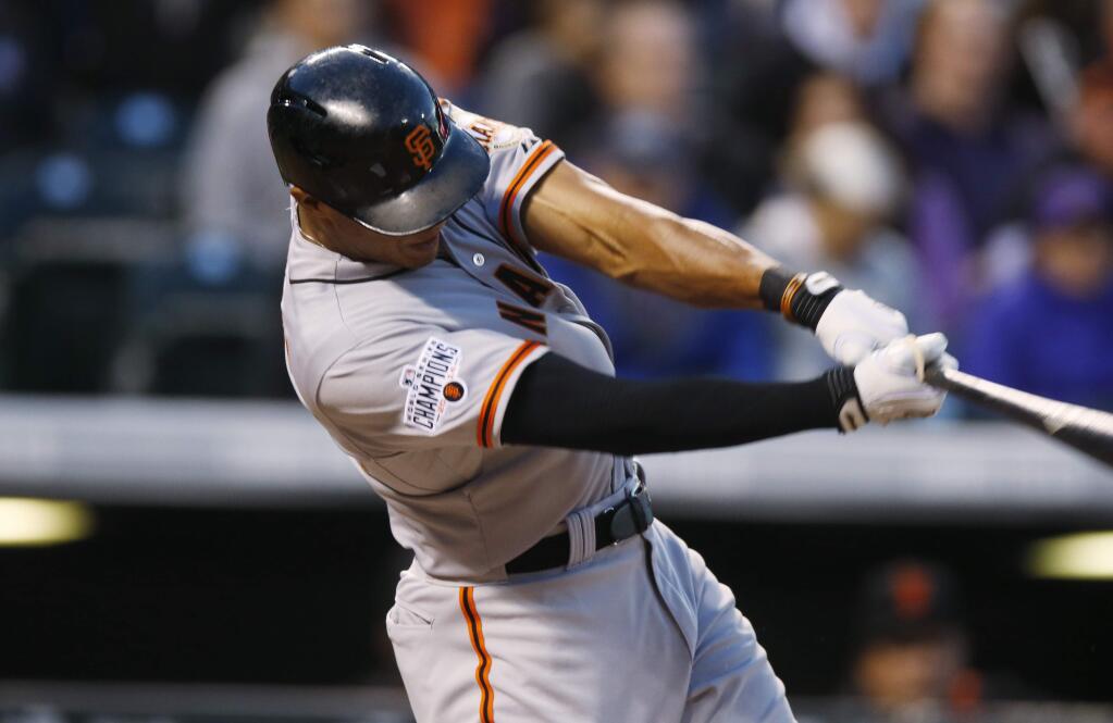San Francisco Giants' Justin Maxwell (43) singles against the Colorado Rockies in the fourth inning of a game Friday, April 24, 2015, in Denver. (AP Photo/David Zalubowski)