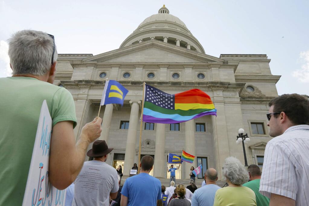 Demonstrators attend a rally on the steps of the Arkansas state Capitol in Little Rock, Ark., Tuesday, March 31, 2015, in protest of a bill that passed in the state House that critics say will lead to discrimination against gays and lesbians. (AP Photo/Danny Johnston)